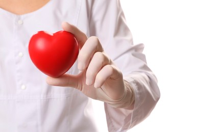 Photo of Doctor in medical glove holding red heart on white background, selective focus