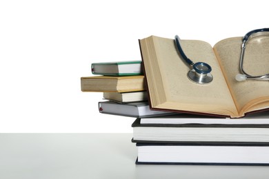 Stethoscope and stack of books isolated on white