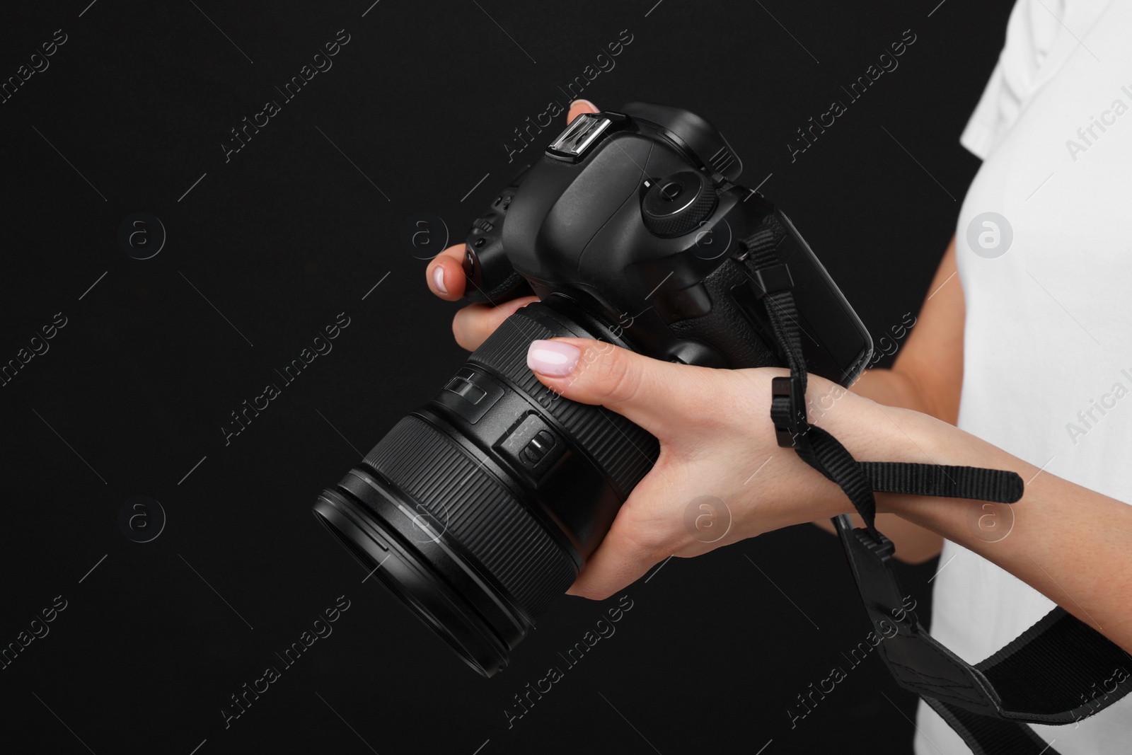 Photo of Photographer with camera on black background, closeup