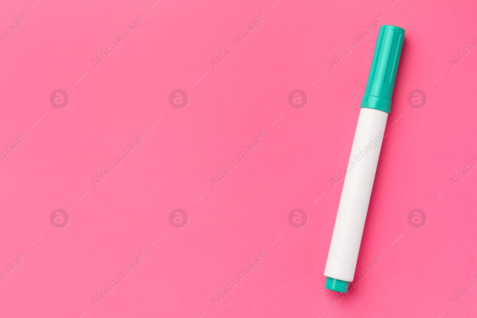 Photo of Bright green marker on pink background, top view. Space for text