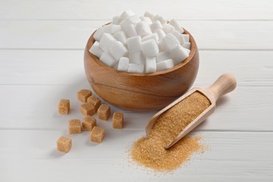 Different types of sugar on white wooden table