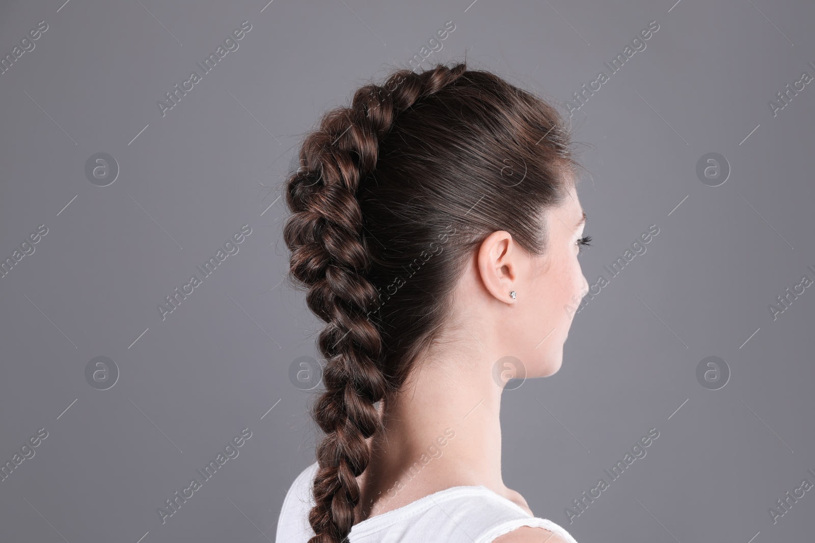 Photo of Woman with braided hair on grey background