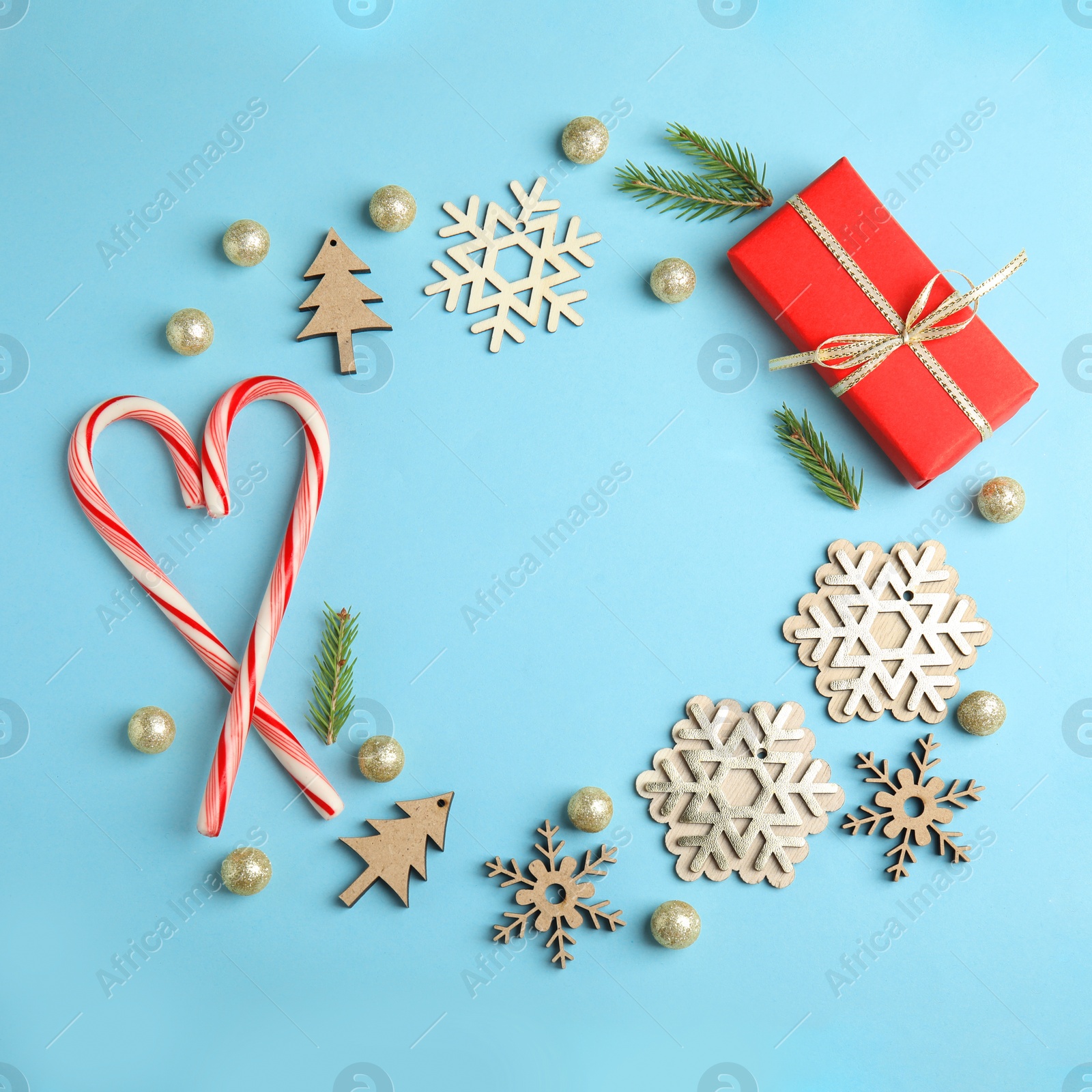 Photo of Frame made with Christmas decor on blue background, flat lay. Space for text