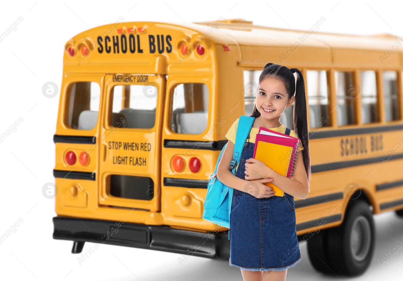 Image of Girl with backpack near yellow school bus. Transport for students