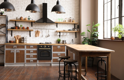 Photo of Beautiful kitchen interior with new stylish furniture and oven