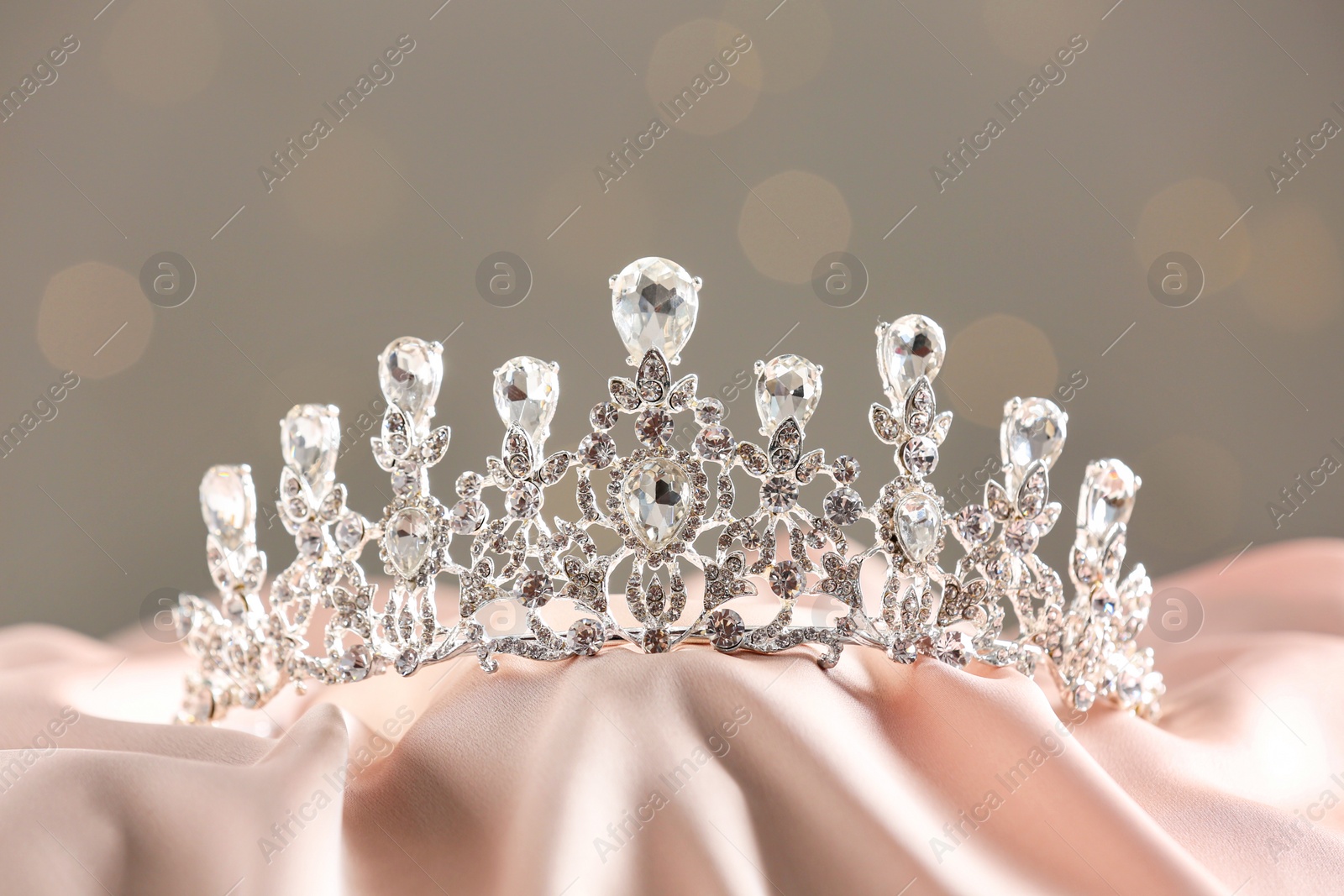 Photo of Beautiful silver tiara with diamonds on light cloth