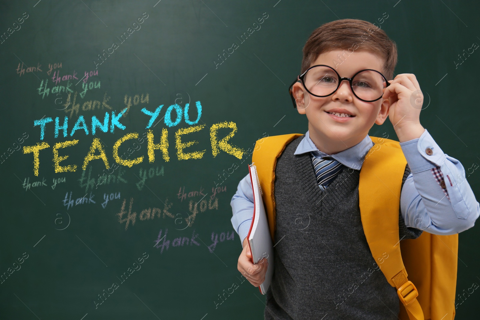 Image of Cute little boy near chalkboard with phrase Thank You Teacher