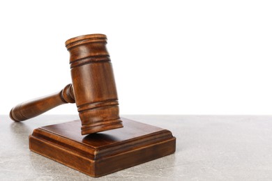 Photo of Wooden gavel on light table against white background. Space for text