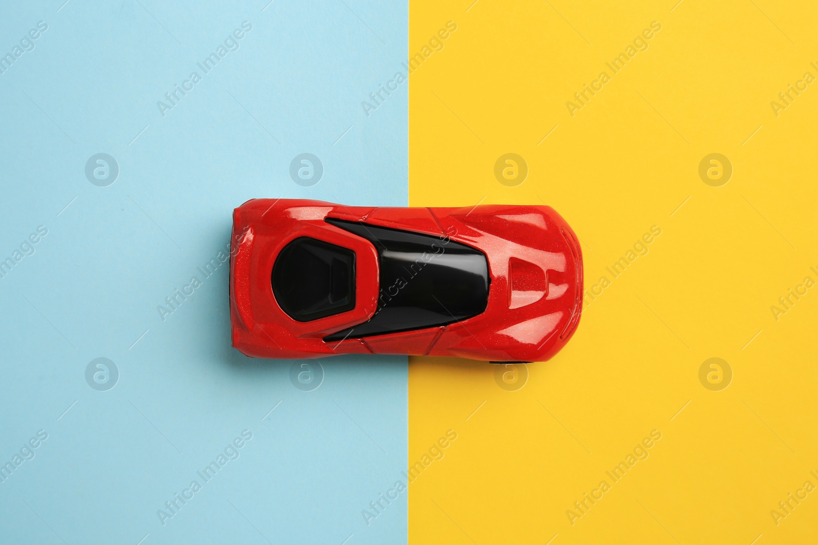 Photo of Red car on color background, top view. Children`s toy