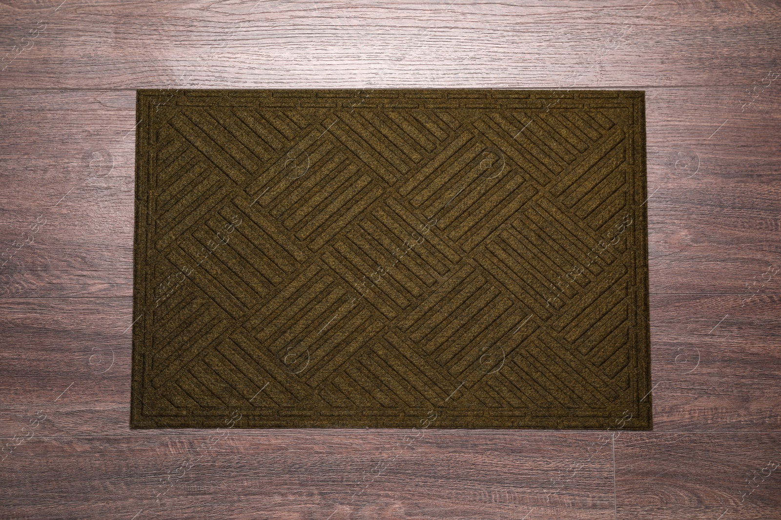 Photo of Stylish door mat on wooden floor, top view