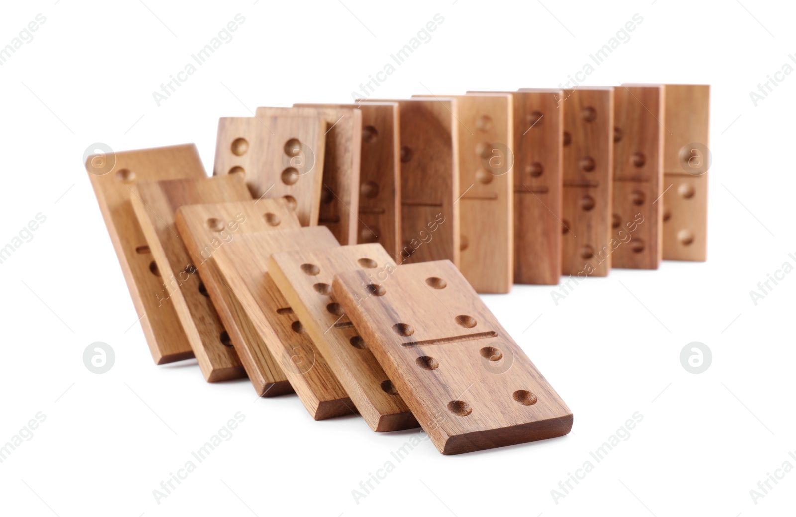 Photo of Wooden domino tiles falling on white background
