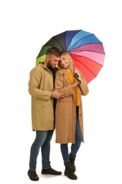 Full length portrait of beautiful couple with umbrella, isolated on white