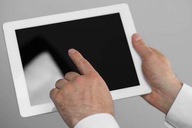 Closeup view of man using new tablet indoors