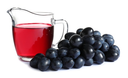 Photo of Jug with wine vinegar and fresh grapes on white background