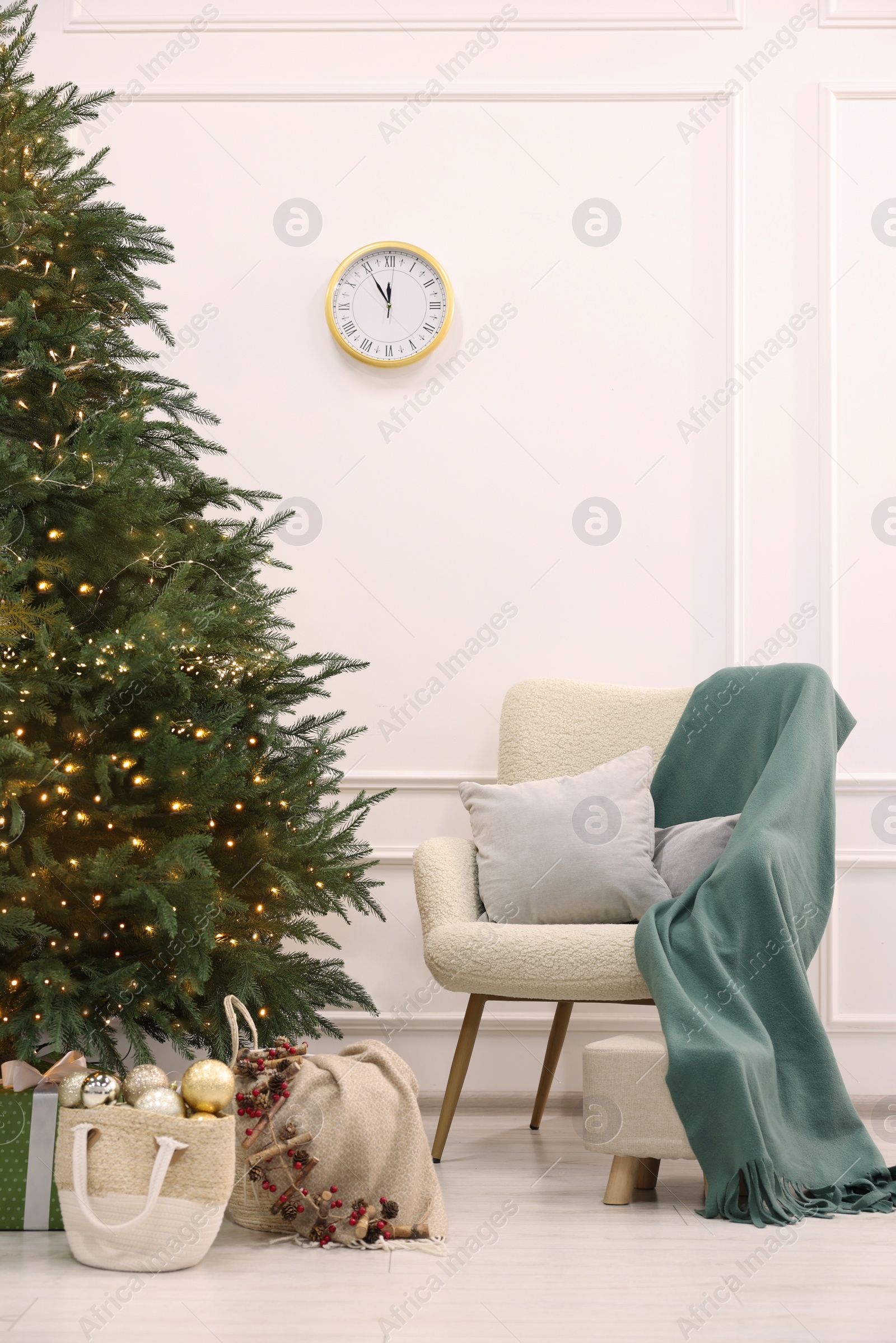 Photo of Many different gift boxes and firewood under Christmas tree indoors