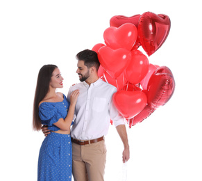 Photo of Happy young couple with heart shaped balloons isolated on white. Valentine's day celebration