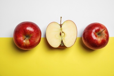 Flat lay composition with ripe juicy red apples on color background