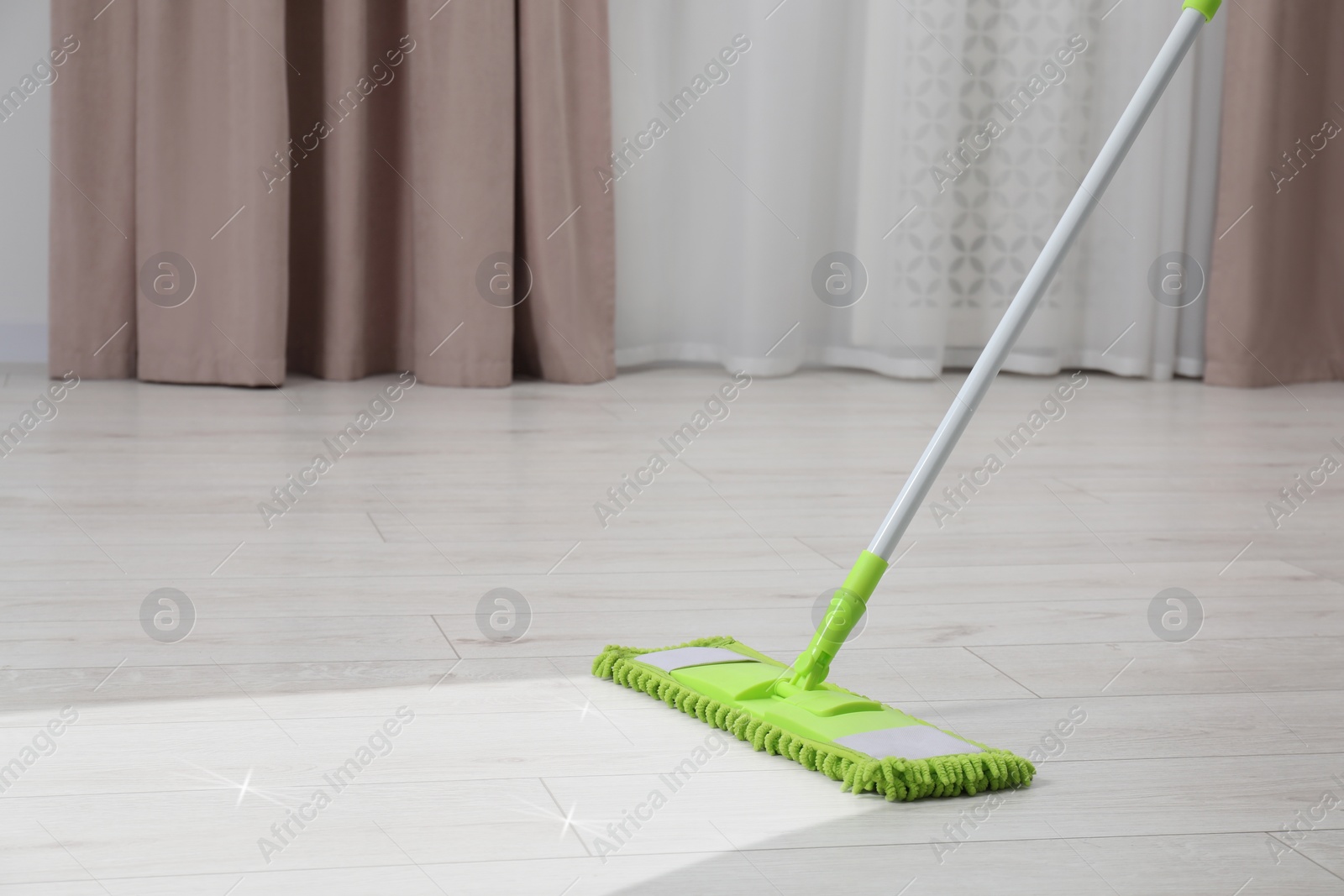 Image of Washing floor with mop in room, space for text. Clean trace on dirty surface