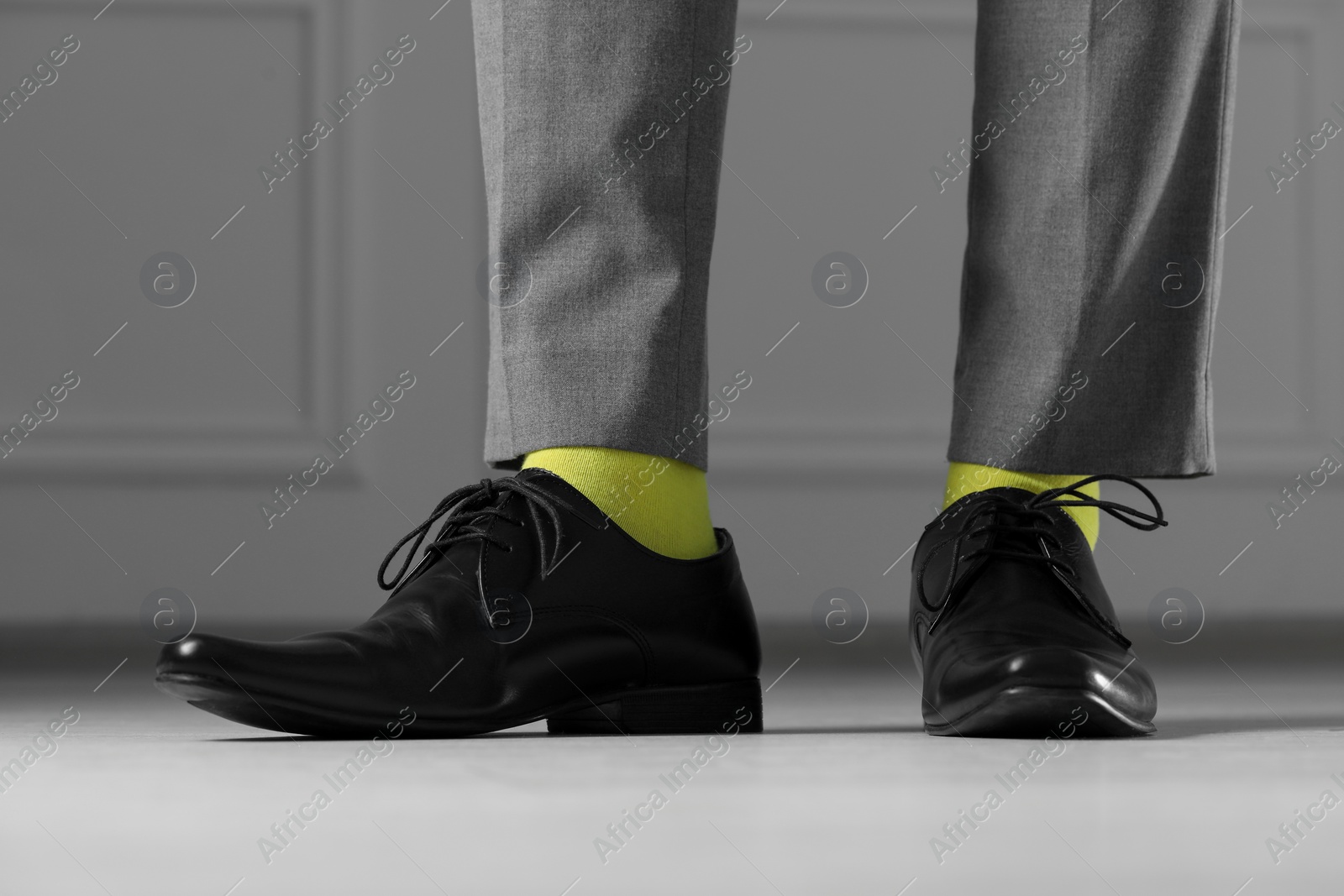 Photo of Man wearing stylish shoes and yellow socks indoors, closeup