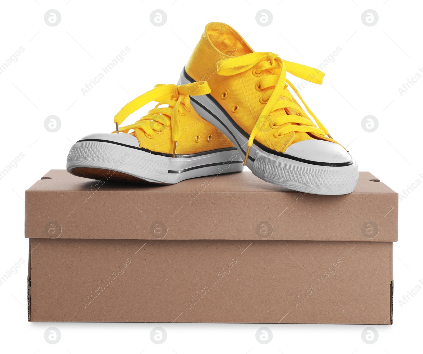 Photo of Pair of stylish sport shoes and cardboard box on white background