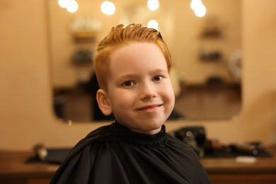 Photo of Little boy with hairstyle in beauty salon