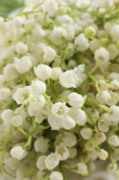 Beautiful lily of the valley bouquet as background, closeup