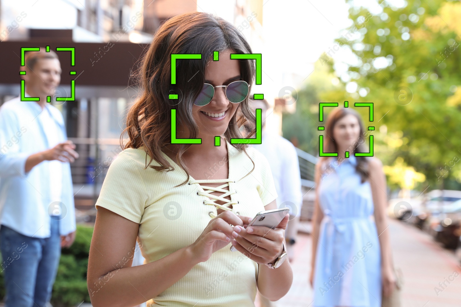 Image of Facial recognition system identifying people on city street 