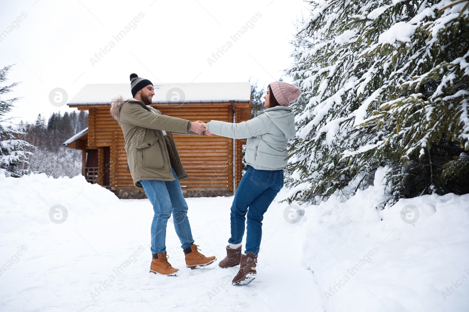 Photo of Lovely couple spending time together on snowy day. Winter vacation