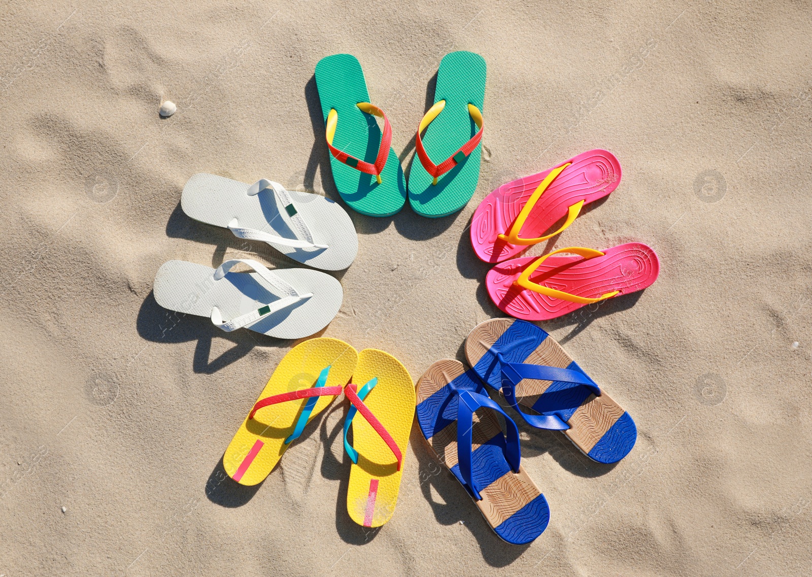 Photo of Stylish flip flops on beach, flat lay