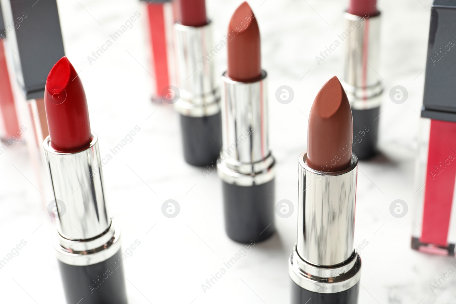 Photo of Different lipsticks on light background. Cosmetic product