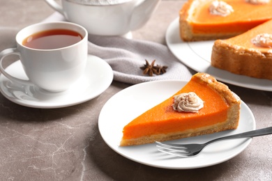 Plate with piece of fresh delicious homemade pumpkin pie served on table