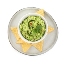 Delicious guacamole served with nachos chips isolated on white, top view