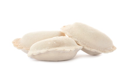 Photo of Raw dumplings with tasty filling on white background