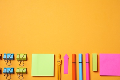 Photo of different school stationery on orange background, flat lay. Space for text