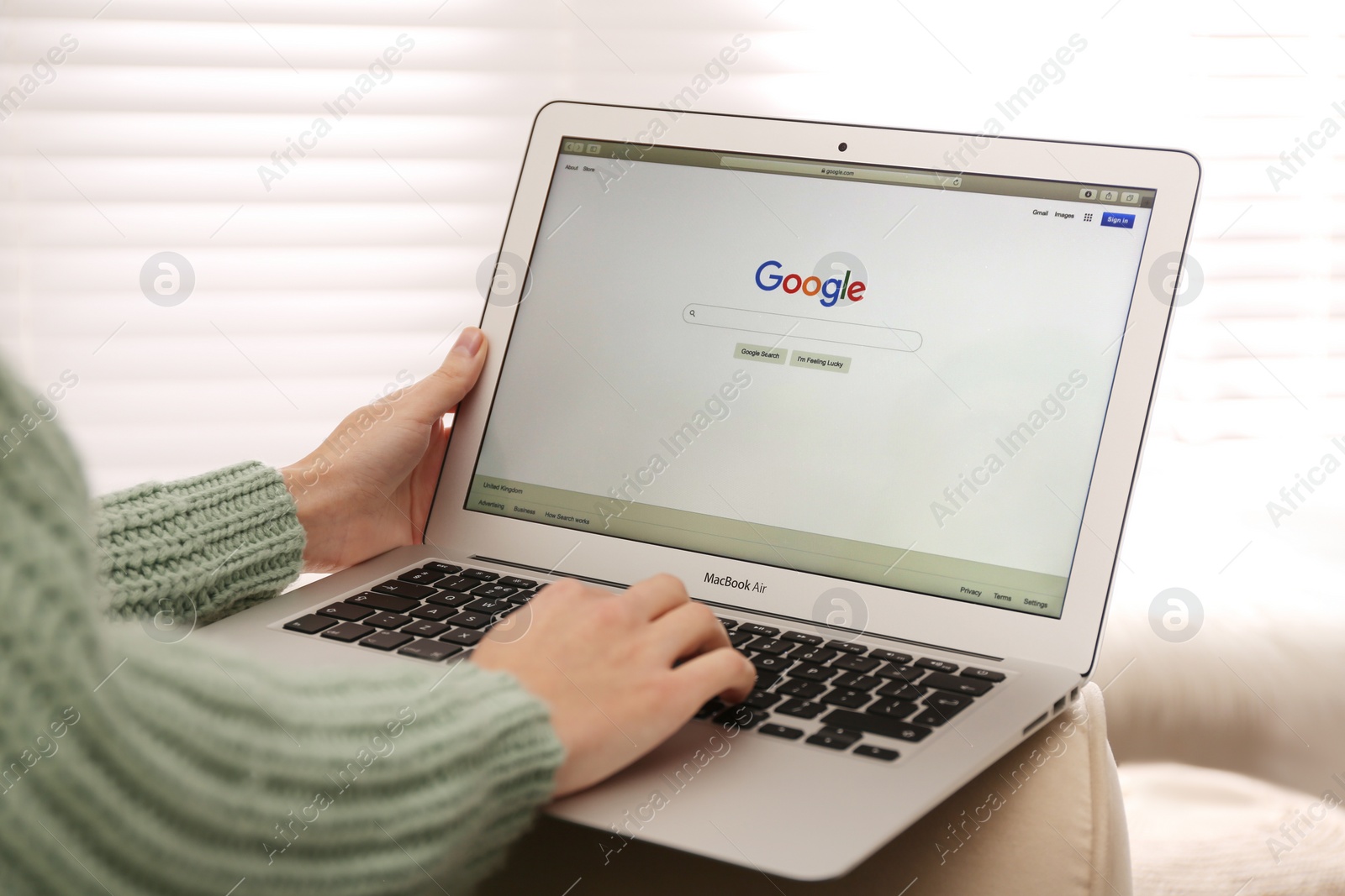 Photo of MYKOLAIV, UKRAINE - NOVEMBER 13, 2020: Woman using Google search on Apple Macbook Air in room, closeup