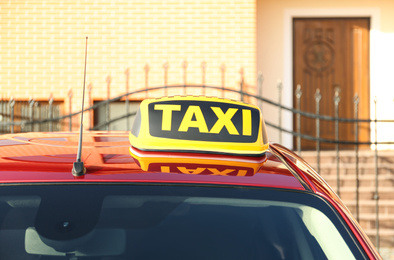 Photo of Roof light with word TAXI on car outdoors