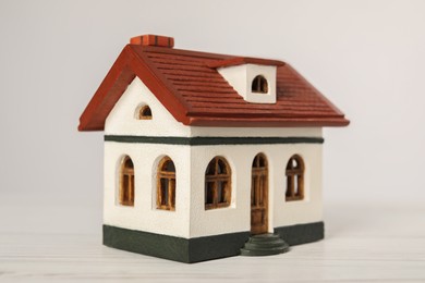 Mortgage concept. House model on white wooden table