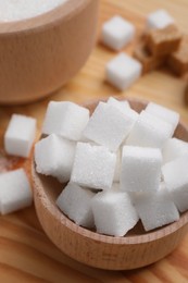 White sugar cubes in bowl on table, above view