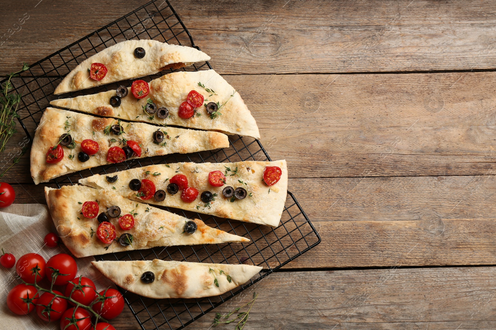 Photo of Flat lay composition with focaccia bread on wooden table. Space for text