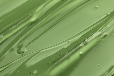 Photo of Clear cosmetic gel on light green background, closeup