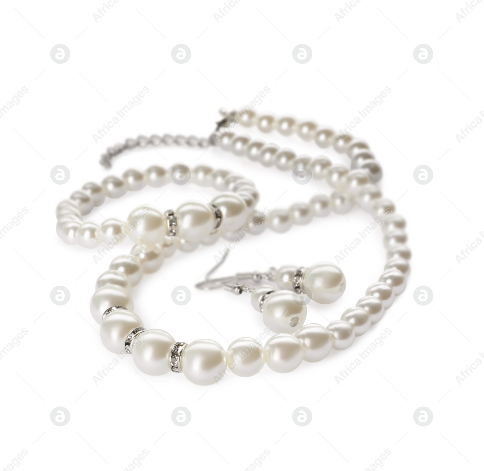 Photo of Elegant pearl necklace, bracelet and earrings on white background