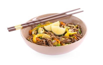 Photo of Stir-fry. Delicious cooked noodles with chicken in bowl and chopsticks isolated on white