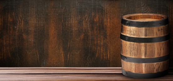 Image of Barrel on wooden background, space for text. Banner design