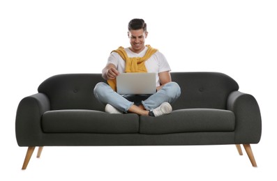 Photo of Man with laptop on comfortable grey sofa against white background