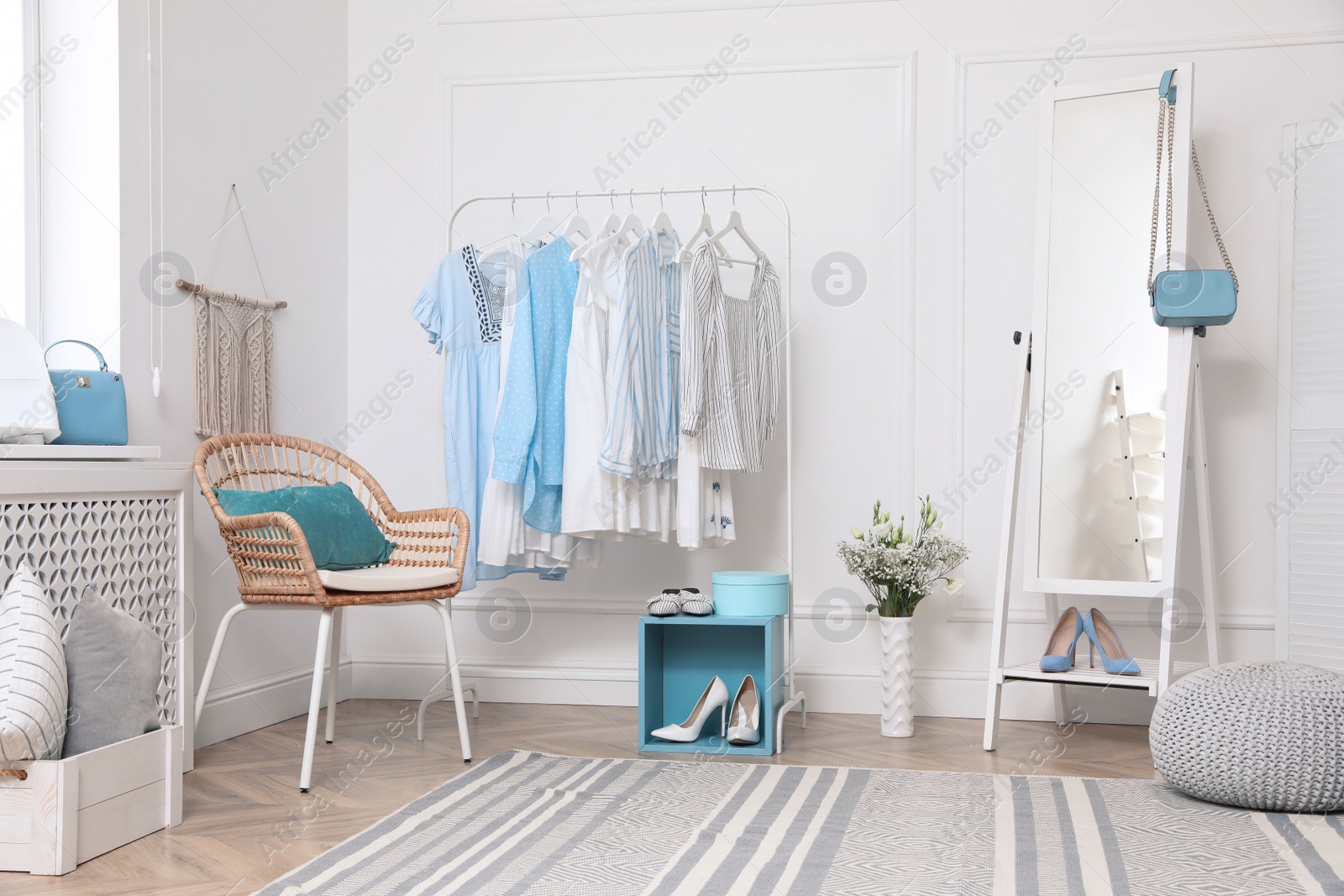 Photo of Dressing room with stylish clothes, shoes and accessories. Elegant interior design