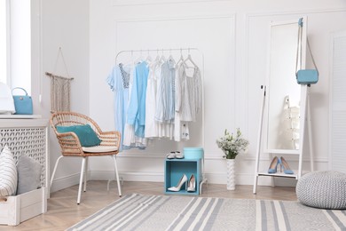 Photo of Dressing room with stylish clothes, shoes and accessories. Elegant interior design