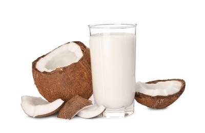 Photo of Glass of delicious vegan milk and coconut pieces on white background