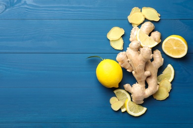 Photo of Fresh lemons and ginger on blue wooden table, flat lay. Space for text