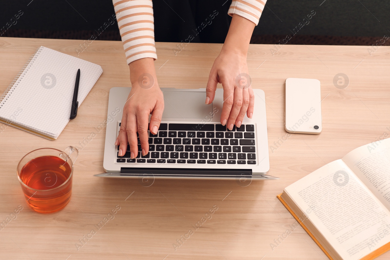 Photo of Woman with modern laptop learning at table indoors, above view