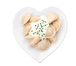 Photo of Delicious cooked dumplings with sour cream on white background, top view